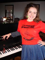 Young soprano singer CHARLOTTE KHUNER (16 y.o.), after rehearsal for the upcoming NAMM Show performance in LA, CA, USA; by her piano in t-shirt with the advocacy for music education through brain research message for the for the int'l campaign http://www.youtube.com/watch?v=rLtLBIxMYgo